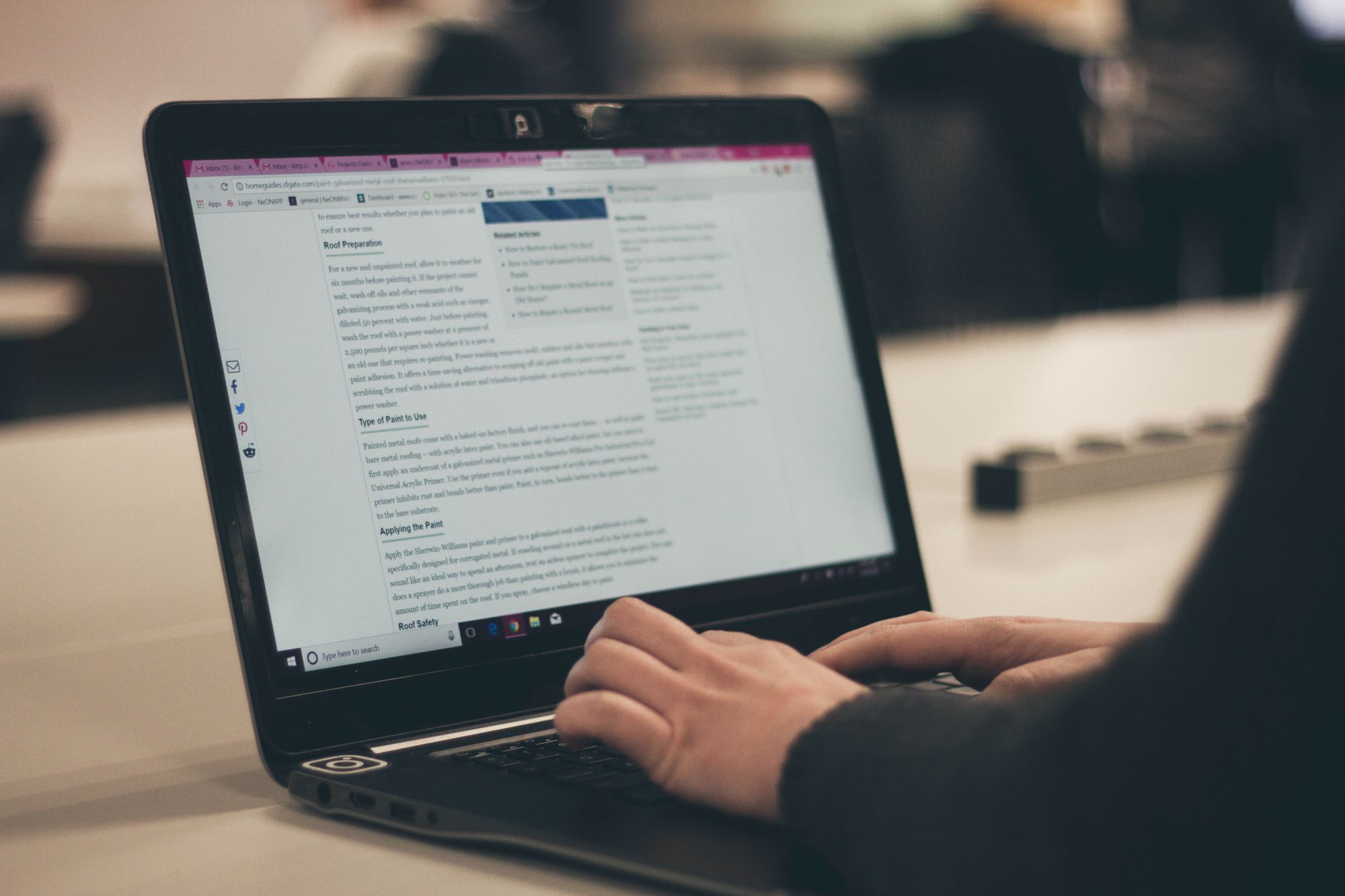 image of a person writing on a laptop.