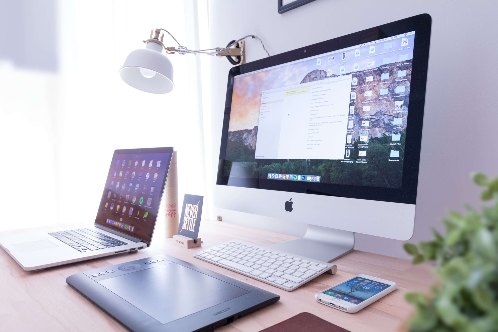 An image of an iMac, Macbook and iPhone