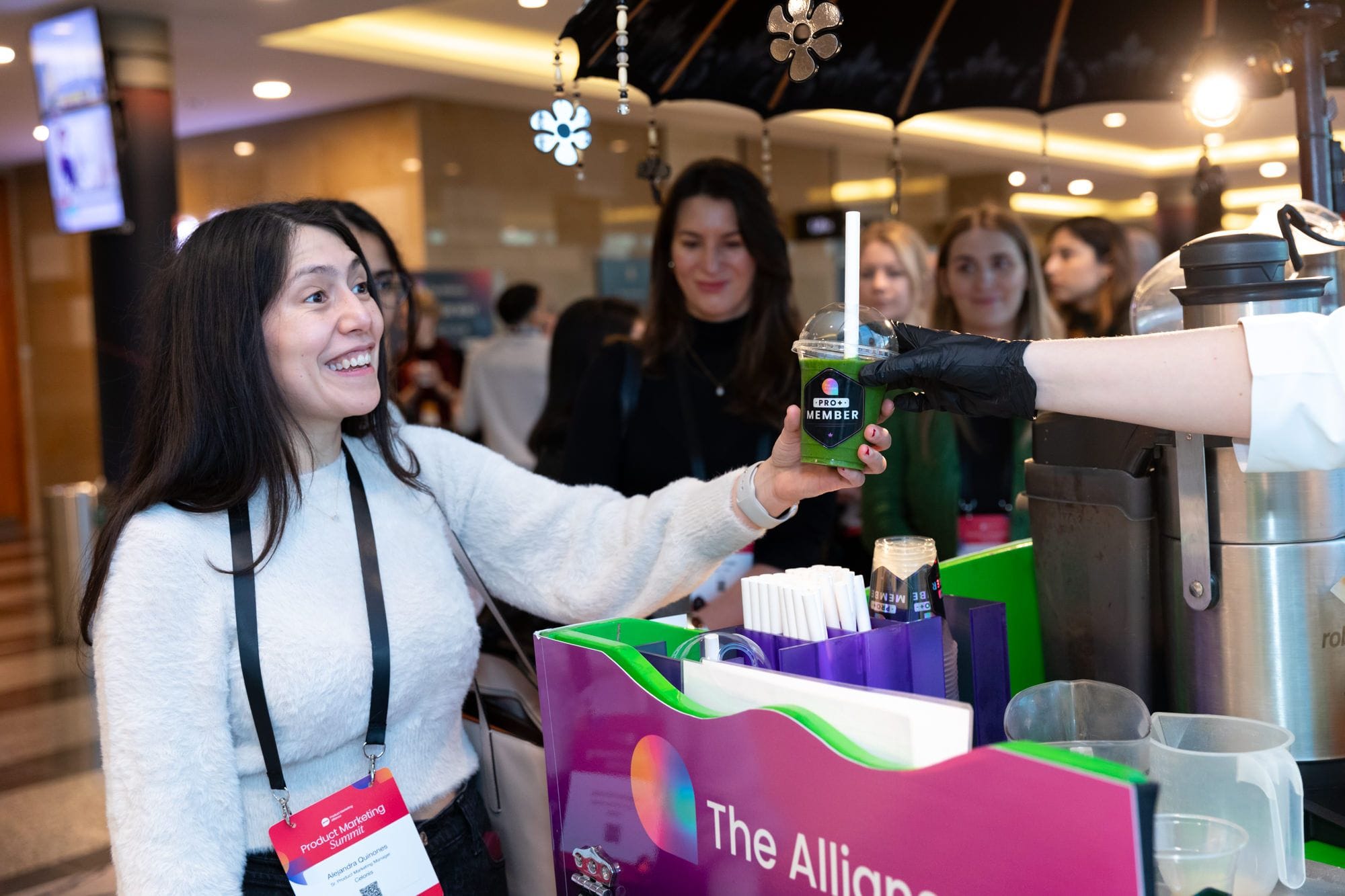 Product Marketing Alliance Pro+ member getting a smoothie at the smoothie stand. 